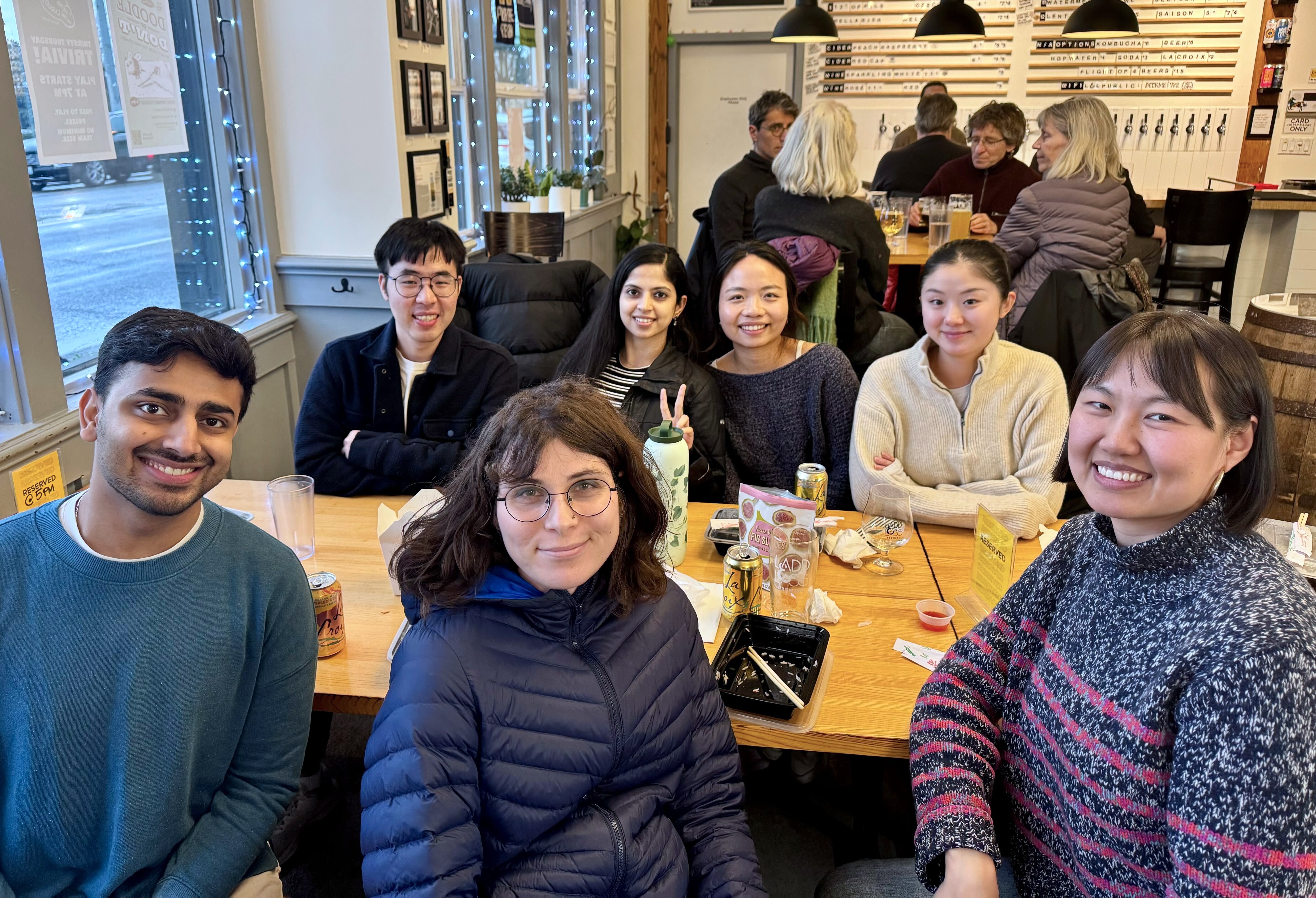 photo of lab members sitting around a table