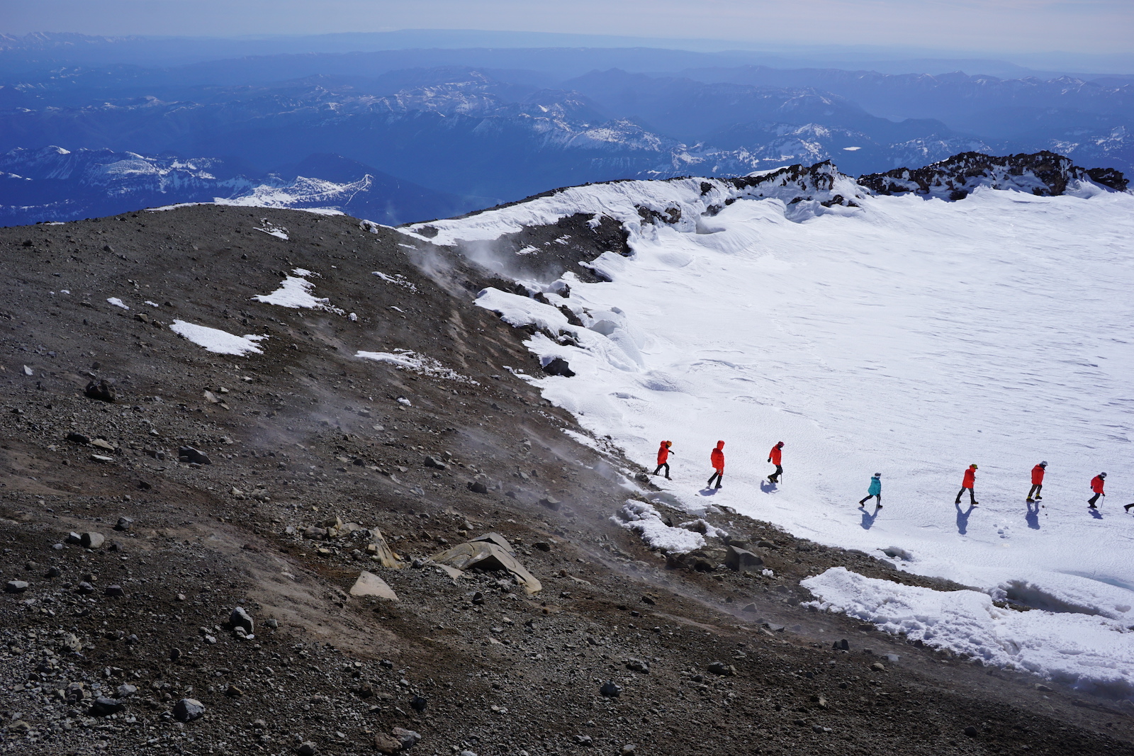 Climbers walking across the crater at the top of Mount Rainier