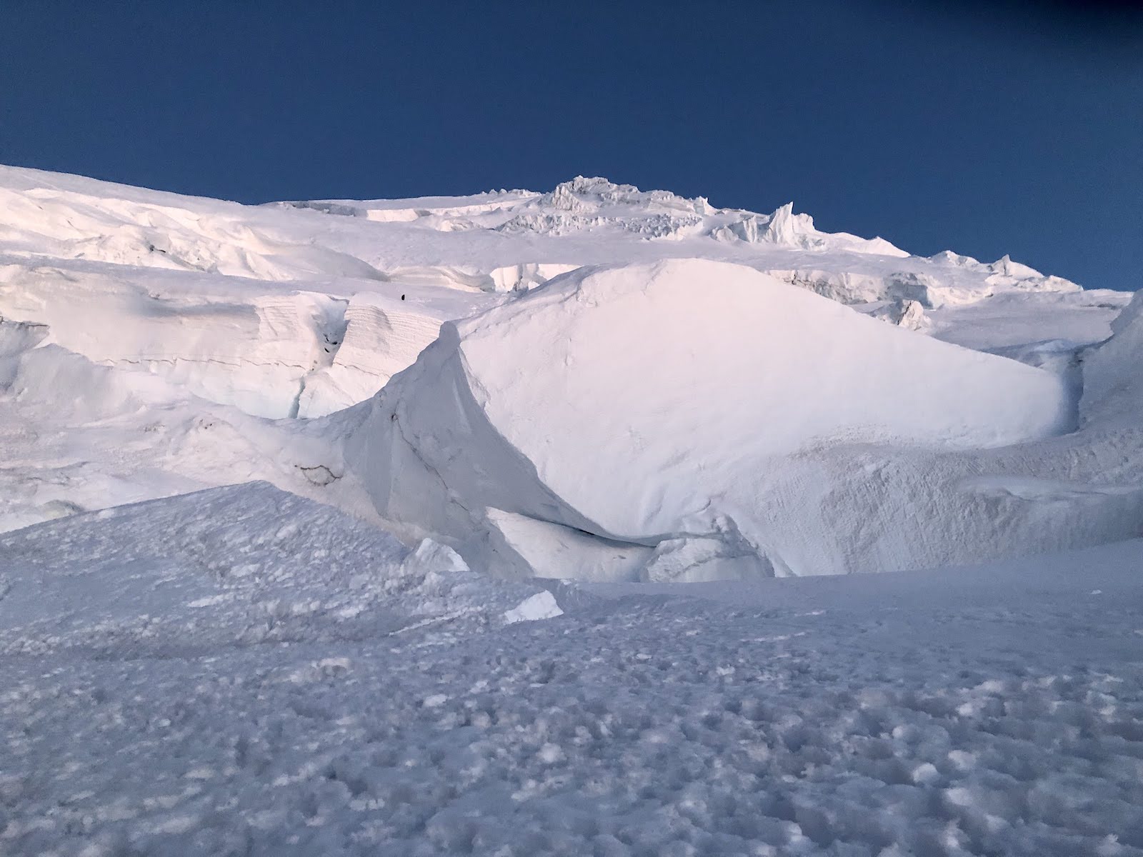 Part of the Ingraham glacier on Mount Rainier with a distant climber