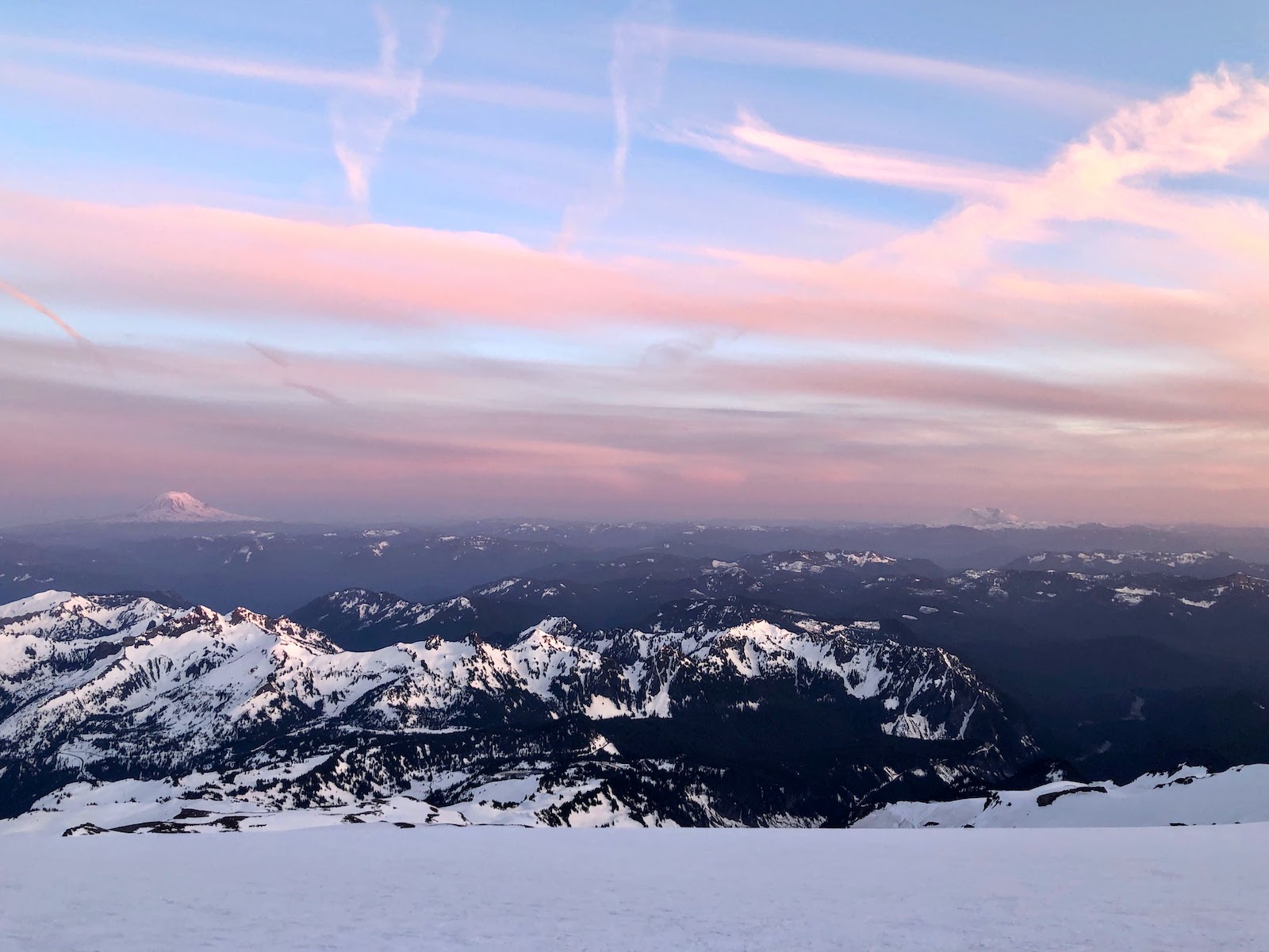 A hazy and beautiful sunset from Camp Muir, with Mount Adams (Pahto) and Mount St Helens (Loowit) in the distance